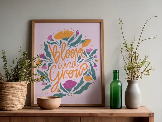 Framed Bloom and Grow lettering print on a sideboard